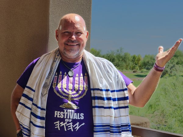 ROCK in a tallit and a purple THE FESTIVALS OF menorah shirt at an Arizona golf course